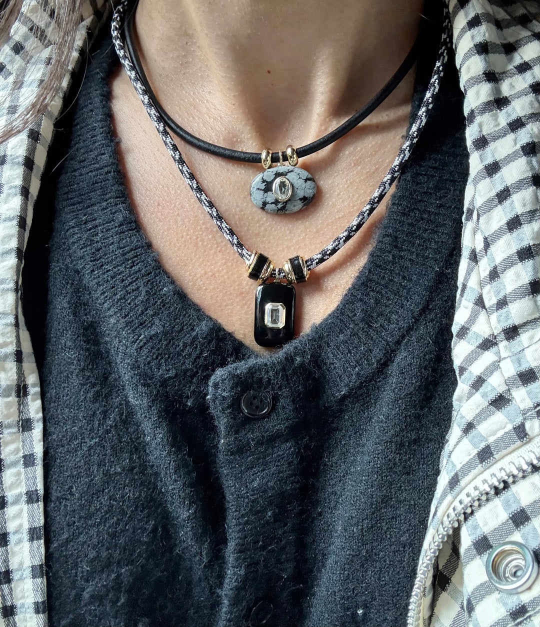 Necklace with pendant on a person.