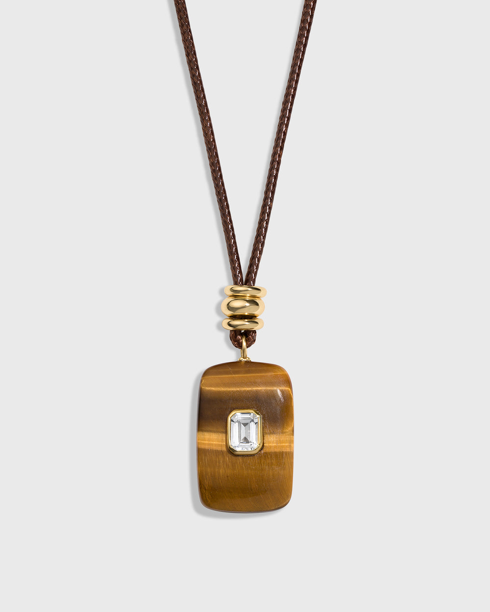 zoom in picture of the tiger eye stone that is brown with the clear gem 