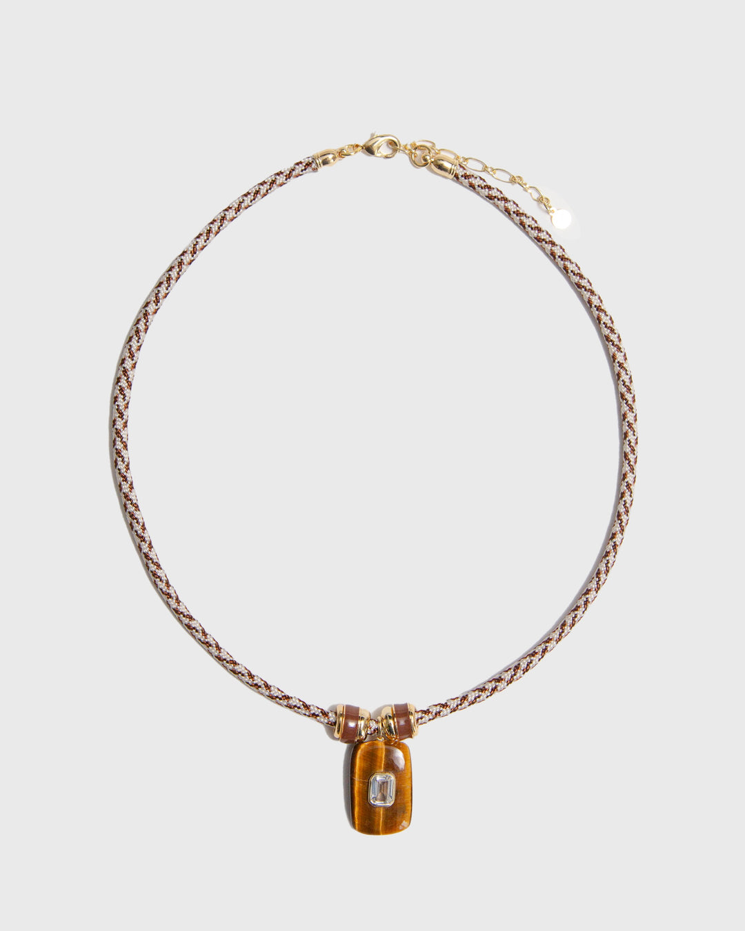 Necklace on paracord and rectangular pendant on a light grey background
