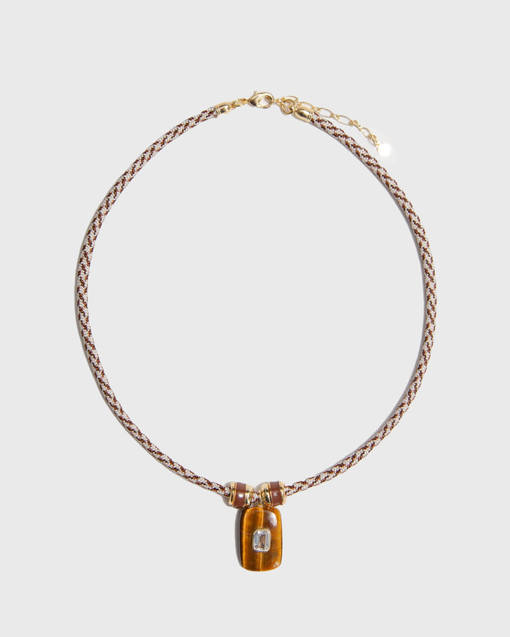 Necklace on paracord and rectangular pendant on a light grey background