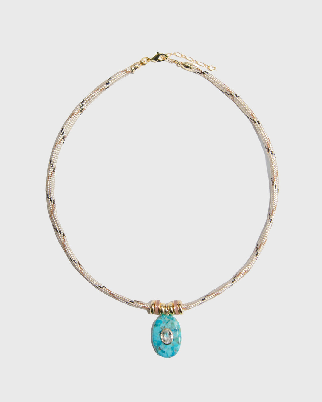 Necklace with a turquoise pendant on a light gray background