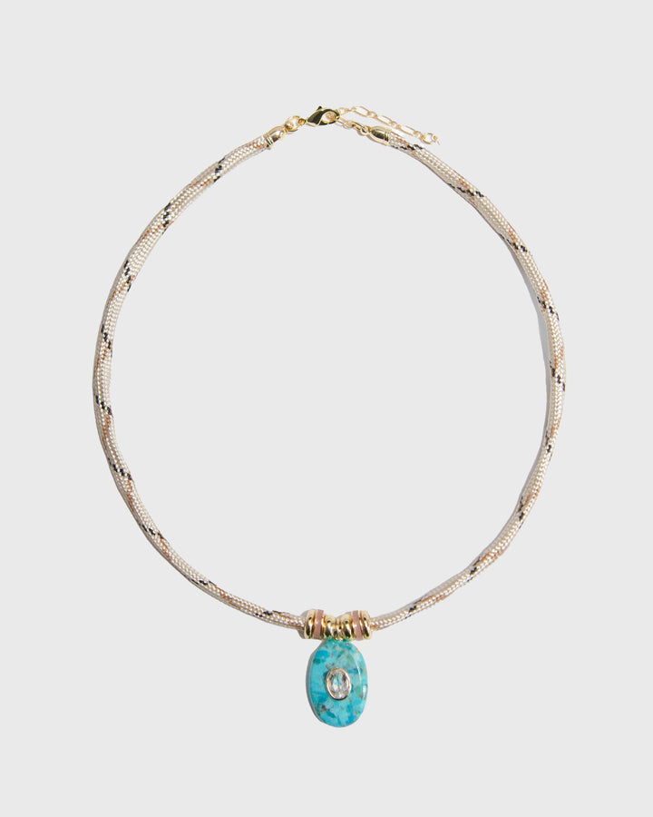 Necklace with a turquoise pendant on a light gray background